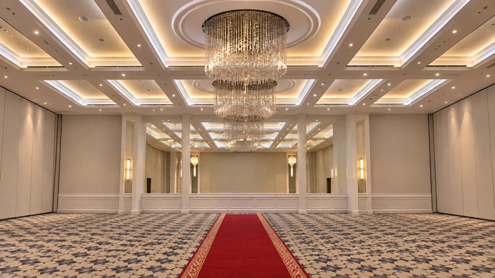 Empty hotel ballroom with crystal chandeliers, before setup begins