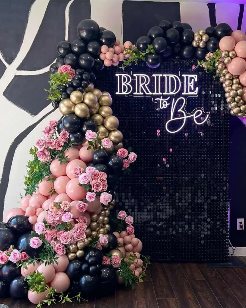 Bridal shower black sequin wall with a Bride to Be neon sign and pink, black and gold balloons — Baraka Events, Lahore