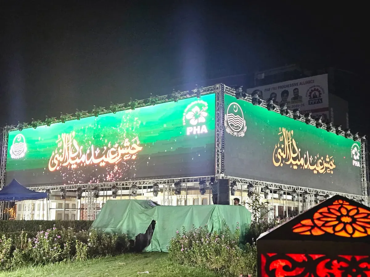 Large outdoor LED screens on a lit truss at night for a public celebration — Baraka Events, Lahore